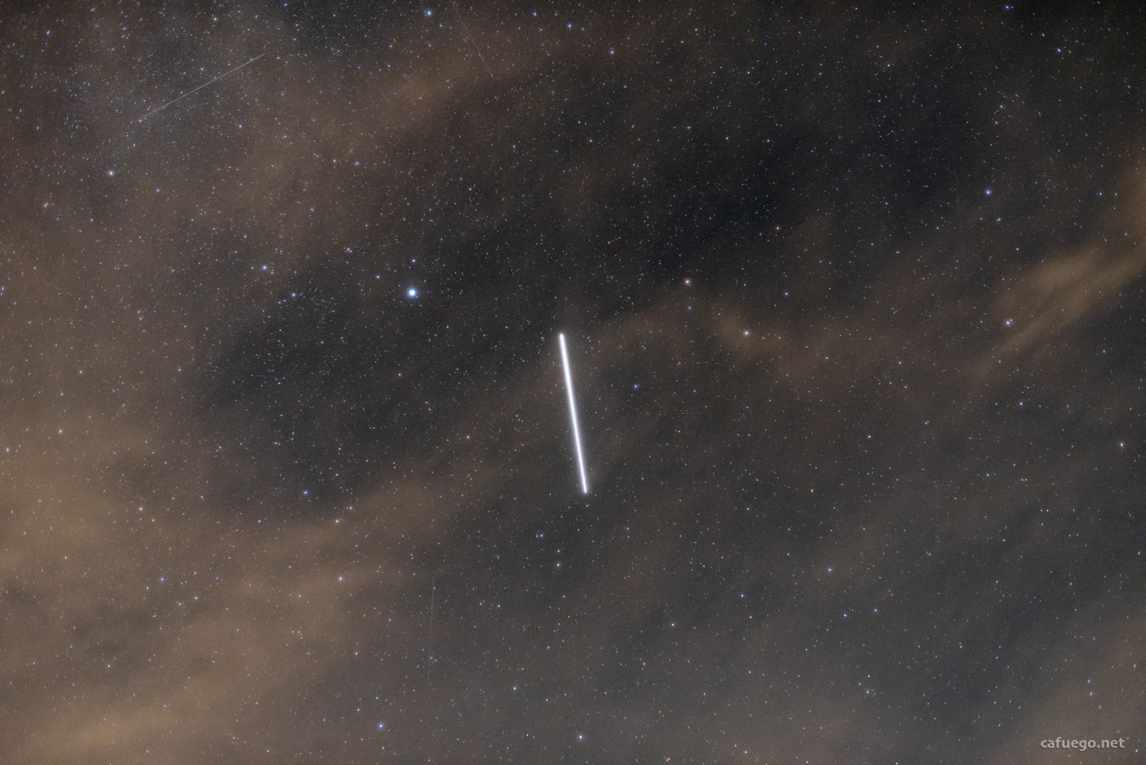 A 10 second exposure of an ISS pass, causing it to create a bright glowing straight line against the stars. Looking for all the world like a light saber.