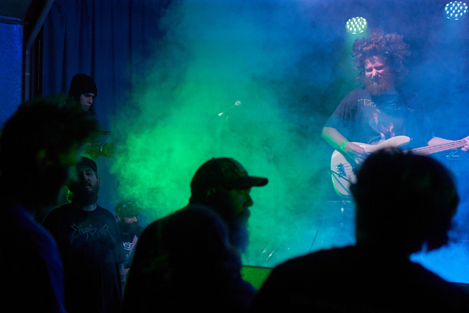 The vocalist had joined the crowd and the bassist dances on stage.