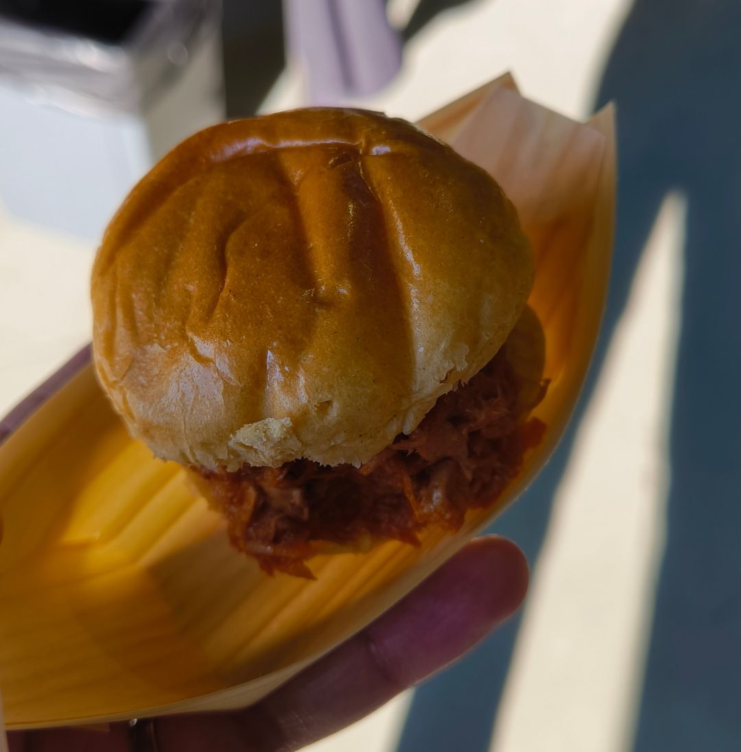 A vegetarian pulled pork slider on a bamboo canape plate.