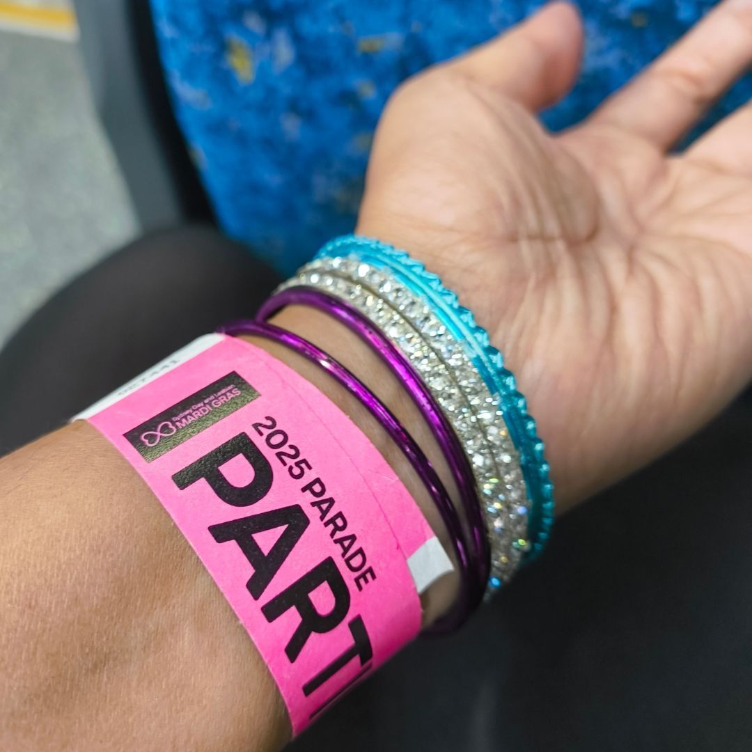 My wrist with a parade participant band and several jingly bracelets, taken on the train home.
