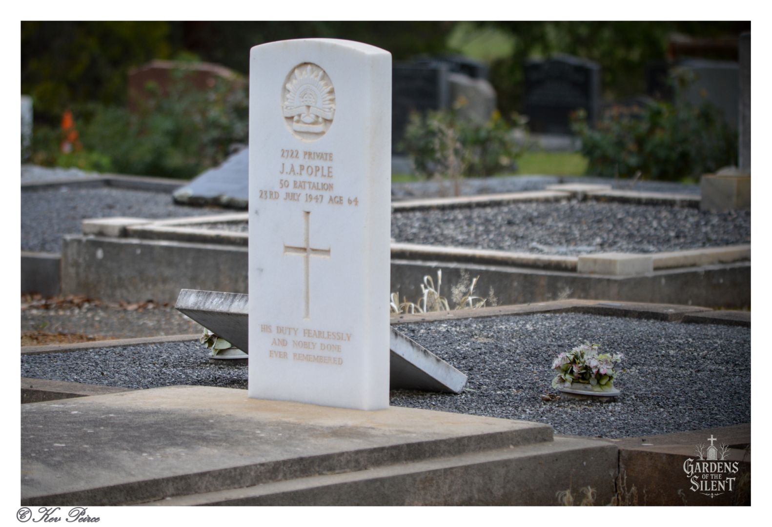 A white marble headstone for Private J.A. Pople, a soldier from the 50th Battalion who died in 1947, is shown standing amongst other graves covered in black gravel.